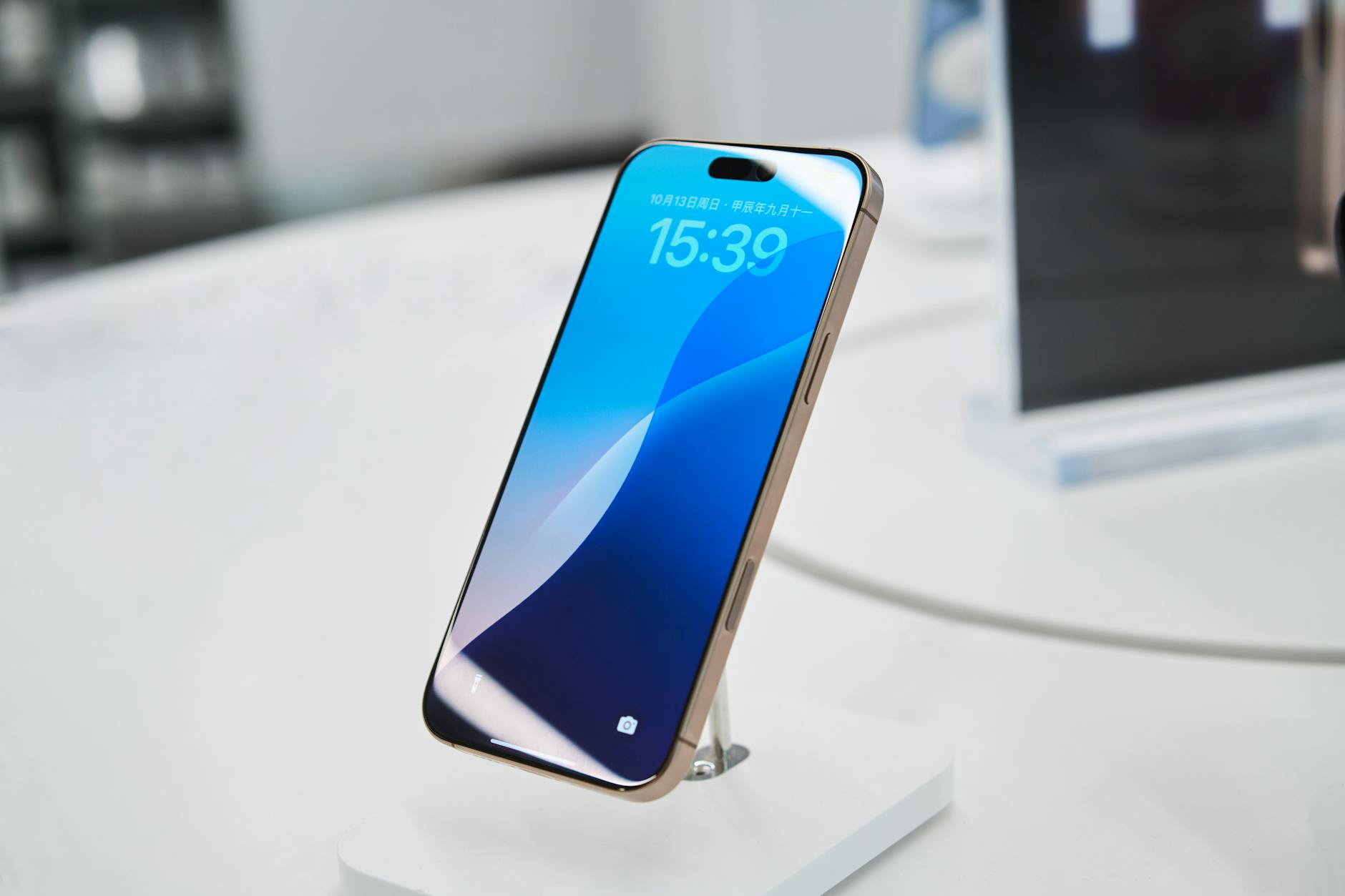 Modern smartphone showcased in a tech store setting, highlighting its sleek design.